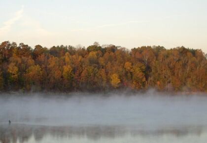 misty morning fisherman in lake monroe